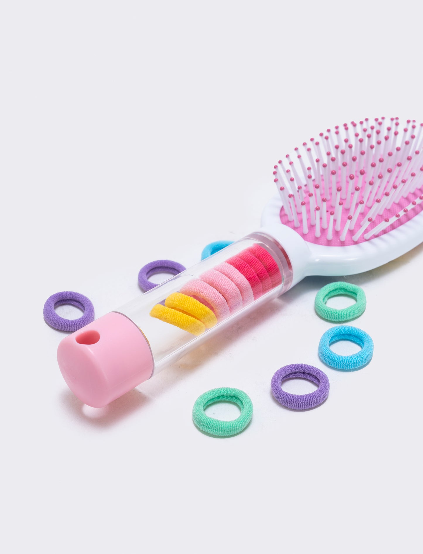 Brush with integrated tube and elastics - Multicolor