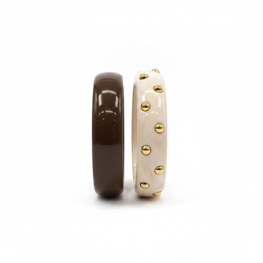 Bracciali rigidi in plastica con borchie - Moro