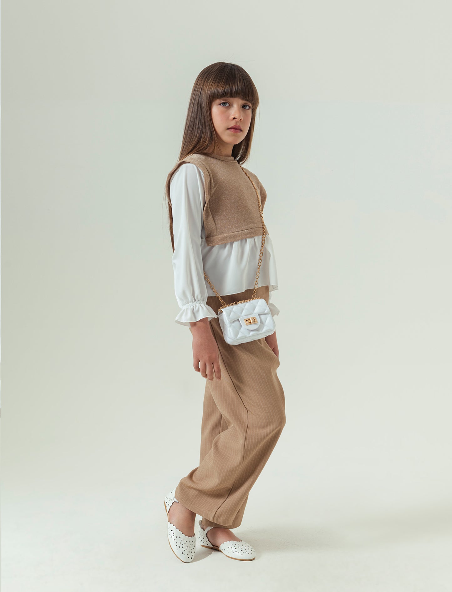 Pantaloni eleganti da bambina in tessuto gessato. - Beige